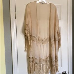 Cream colored shrug / bathing suit cover up.